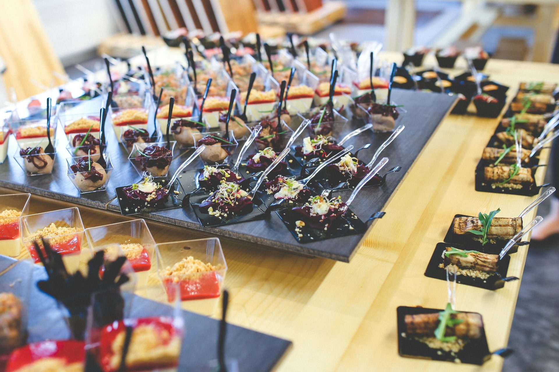 Colorful assorted gourmet finger foods beautifully displayed on a table for an event.